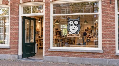 Illustrative workshop location in a historic building, with The Owl’s Nest owl sign hanging behind the window